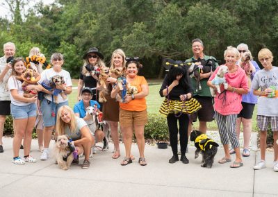 Howl-O-Ween 2021 group of people with their dogs in Halloween costumes in sarasota